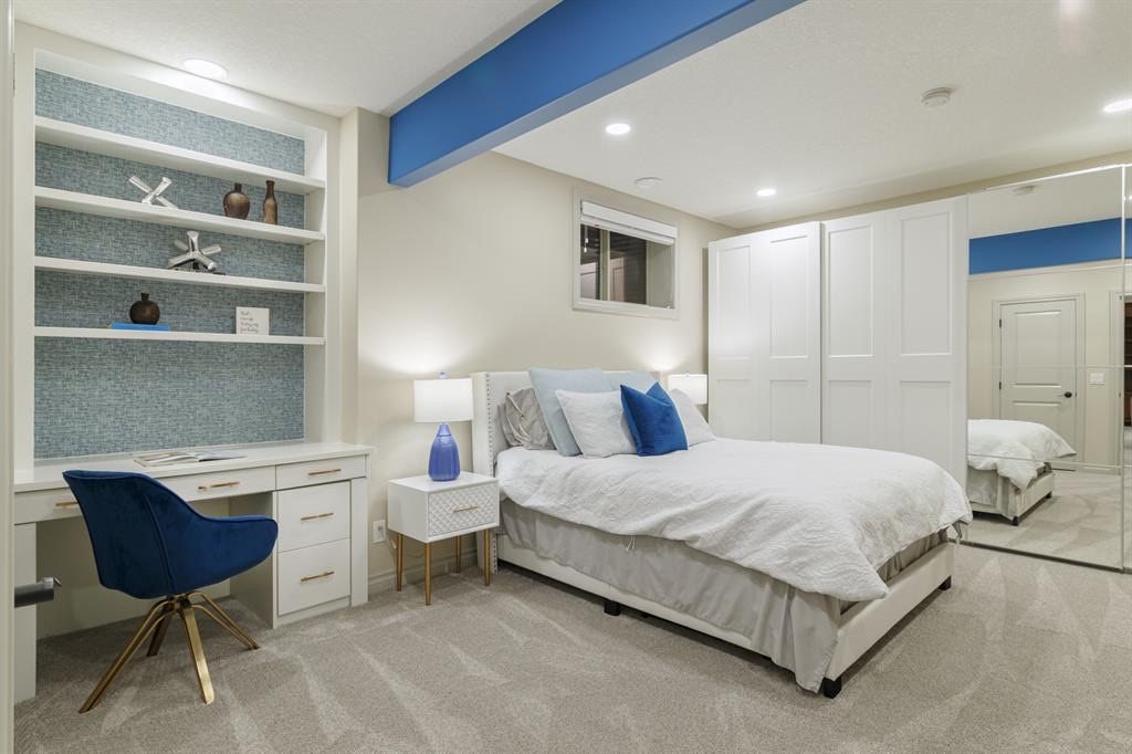 Lower-level bedroom with built-in desk and shelving