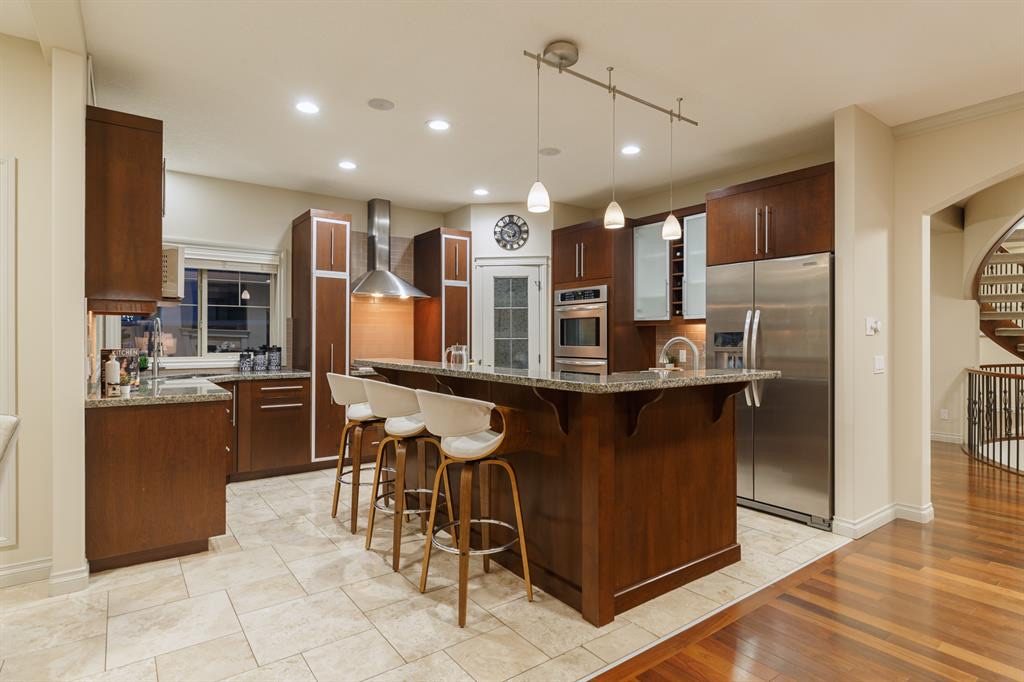 Kitchen with island, stainless appliances and pendant lights
