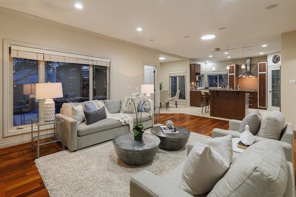 Family room with large windows, open to the kitchen